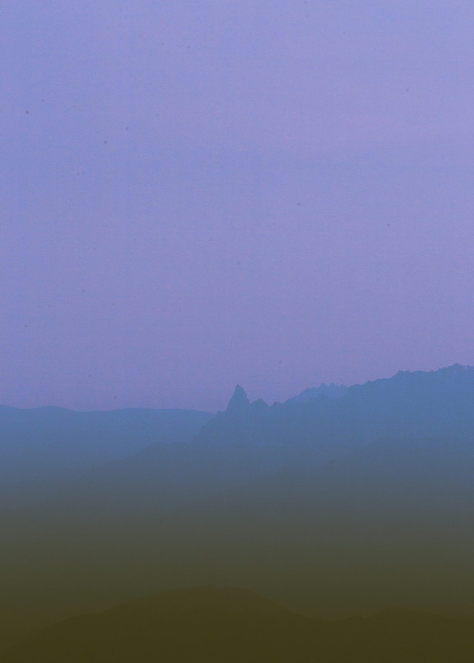 silhouette of mountain during foggy day